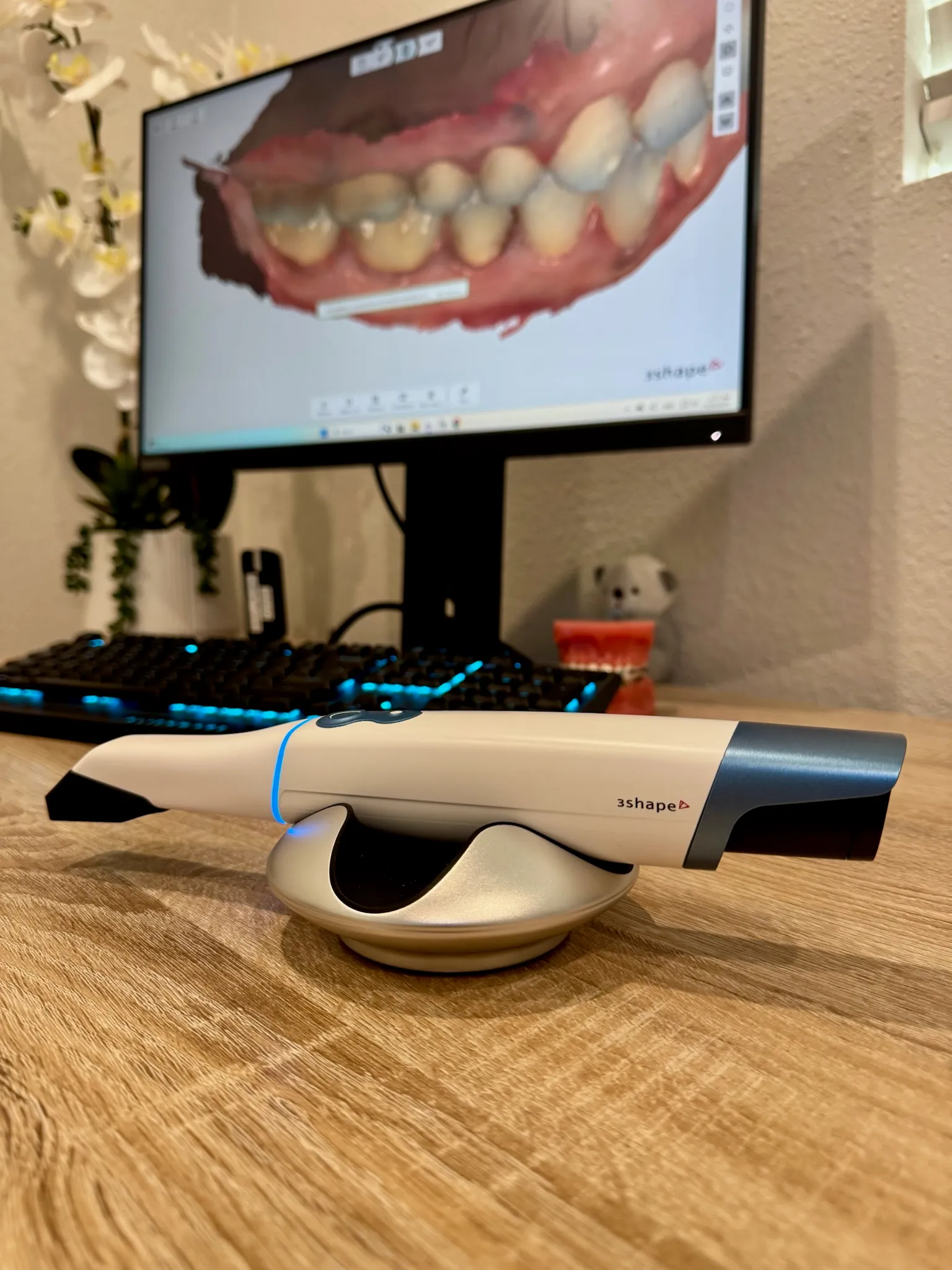 Intraoral 3-D scanner capturing a live digital model of a patient’s teeth