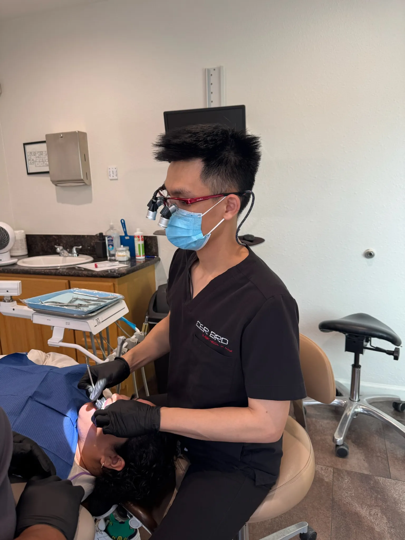 Dr. Bradley performing treatment with surgical loupes at Care Dental