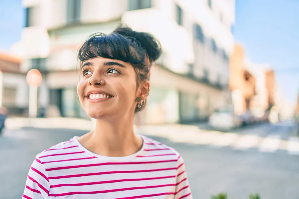 Confident patient with implant-supported dentures
